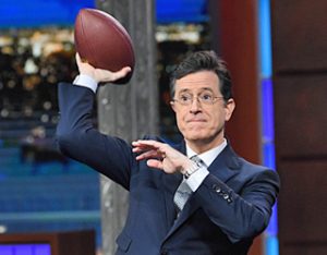 Stephen Colbert throwing a football