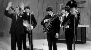 Black and white image of The Beatles on the Ed Sullivan Show