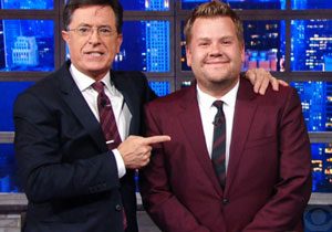 Stephen Colbert standing with James Corden